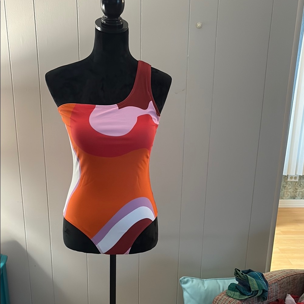 One piece, one shoulder, bathing suit, and matching sarong.